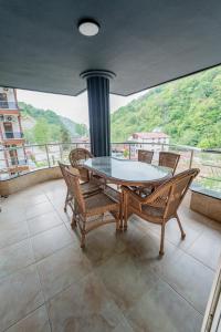 a table and chairs on a balcony with a view at 53 BRN hotel in Ardeşen