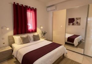 a bedroom with a large bed with a red window at Tac-Coghki Maisonette in Rabat