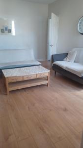 a bedroom with a bed and a coffee table at 3 Bedroom Apartment near the Beach in South Shields