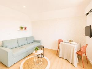a living room with a couch and a table at M114 Magnifique T2 aux portes de la douane de Moillesulaz in Gaillard