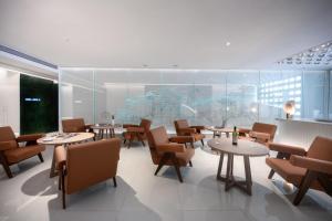 a restaurant with tables and chairs and a map on the wall at Aspera Star Essence Sky Garden Panoramic Hotel-Jiefangbei Hongya Branch in Chongqing