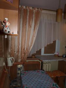 a room with a table and a window and a desk at Rent Zhytomyr Apart in Zhytomyr