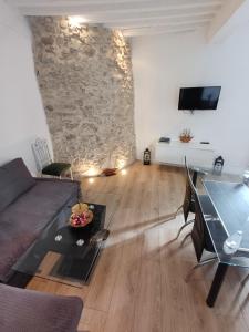 a living room with a couch and a table at Au Thiernois in Thiers
