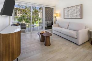 a living room with a couch and a table at Olas del Mar by Playa Caracol Resorts in Palmira