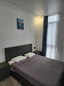 a bedroom with a large bed and a window at Magnetoria 3 BR House in pine forest - 3 mins to the sea in Urekis Sadguri