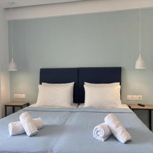 two towels on a bed with two pillows on it at Kostas Apartments in Stalís