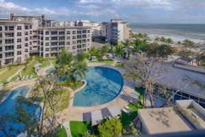 an aerial view of a resort with a swimming pool and the ocean at Olas del Mar by Playa Caracol Resorts in Palmira