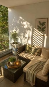 a living room with a couch and a table at Luxury Coastal Escape Coral Point Sibaya Pool & WiFi in Durban
