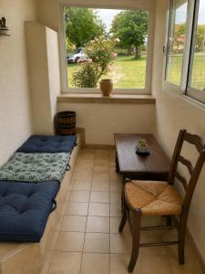 a room with a bed and a table and a window at La Parenthèse du Lot in Gramat +3 photos