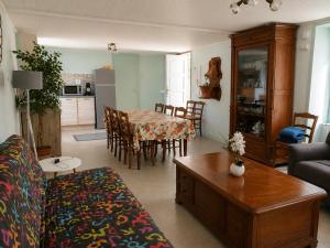 a living room with a couch and a table at La Parenthèse du Lot in Gramat