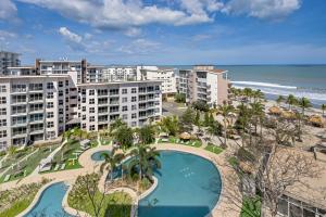 an aerial view of a resort with a swimming pool and the beach at Olas del Mar by Playa Caracol Resorts in Palmira