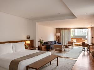 a hotel room with a bed and a living room at Hotel Fasano Belo Horizonte in Belo Horizonte +66 photos
