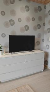 a flat screen tv on top of a white dresser at Sorvarinraitin Helmi in Seinäjoki