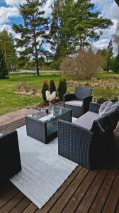 a patio with a table and chairs on a deck at Sorvarinraitin Helmi in Seinäjoki