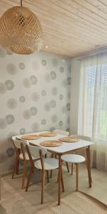 a dining room with a white table and chairs at Sorvarinraitin Helmi in Seinäjoki