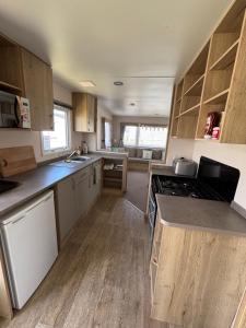 a kitchen with wooden cabinets and a stove top oven at Seaview Holiday Rentals - Arizona pet friendly in Chestfield