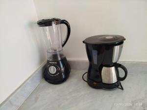 a blender and a coffee maker sitting next to a wall at Flat Gute Morro - Praça Central in Cairu
