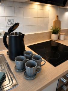 a kitchen counter with four coffee cups on a stove at Niklasdorf Bergblick/Erholung in Niklasdorf