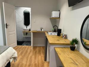 a small bathroom with a sink and a mirror at Bel-Air Guesthouse in Klerksdorp +30 photos