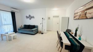 a living room with a blue couch and a table at Diana Apartments in Arad +14 photos