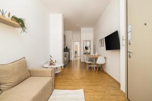 a living room with a couch and a table at Ourania Lofts and Suites in Thessaloniki