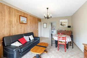 a living room with a couch and a table at Gîte Charly in Salignac Eyvigues