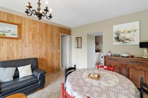 a living room with a table and a couch at Gîte Charly in Salignac Eyvigues +15 photos