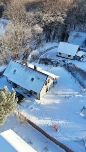 an aerial view of a house covered in snow at Leśna Przystań in Sasino