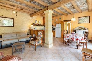 a living room with a couch and a table at Gite Four De Mon Père in Salignac Eyvigues