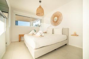 a living room with a white couch and a window at Silver Tower 7A in Ifach +34 photos