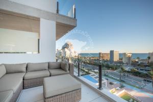 a living room with a couch and a view of a city at Silver Tower 7A in Ifach