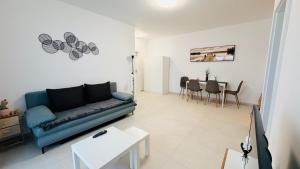 a living room with a blue couch and a table at Diana Apartments in Arad