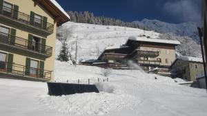 a pile of snow in front of a building at Casa Debora in Valdidentro