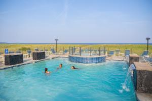 two people in the swimming pool at a resort at Waves Oceanfront Resort in Old Orchard Beach