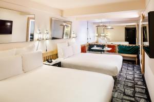 a hotel room with two beds and a bathroom at ARK Shoreditch in London