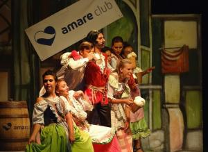 a group of people on the stage in a performance at Hotel Malaspina in Bosa
