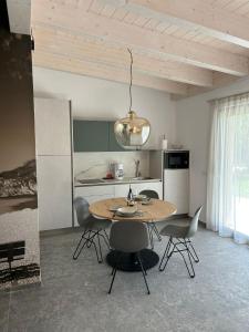 a kitchen with a table and chairs in a room at Oliveto Apartments in Riva del Garda