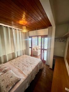 a bedroom with a bed and a chair in it at Rainha do gelo in Barra Grande