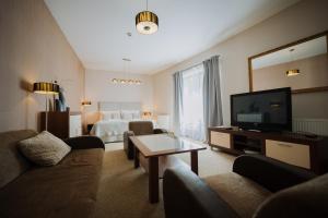 a large hotel room with a bed and a television at Hotel Rokoko Košice - free parking in Košice