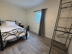 a bedroom with a bed and a ladder next to a window at Woodford Rest in Woodford