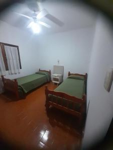 a bedroom with two beds and a ceiling fan at tabaquillo in Villa Cura Brochero
