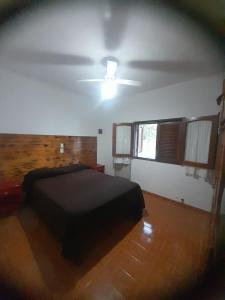 a bedroom with a bed and a ceiling fan at tabaquillo in Villa Cura Brochero