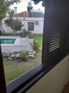 a window view of a yard with a swimming pool at tabaquillo in Villa Cura Brochero