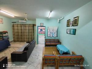 a living room with a couch and chairs in it at Homestay Dasuqi #Musl!m only in Seremban