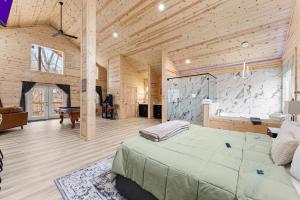 a bedroom with a large bed in a wooden room at Hilltop Haven Treehouse in Cornelia