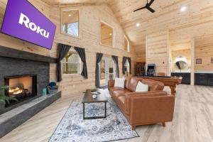 a living room with a couch and a fireplace at Hilltop Haven Treehouse in Cornelia