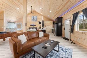 a living room with a couch and a table at Hilltop Haven Treehouse in Cornelia