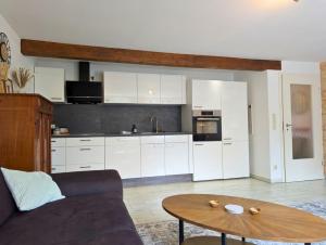 a living room with a couch and a table at Hofidyll Burg - ruhige 75qm FeWo im Zentrum mit Terrasse & Biergarten - bis 6 Personen in Burg