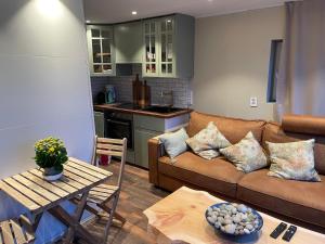 a living room with a couch and a table at Småstranda 7B Boathouse in Store Teisten