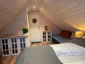 a bedroom with a bed in a attic at Småstranda 7B Boathouse in Store Teisten